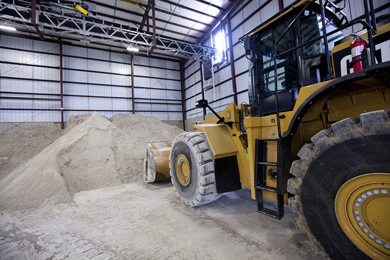 front end loader near a pile of gypsum
